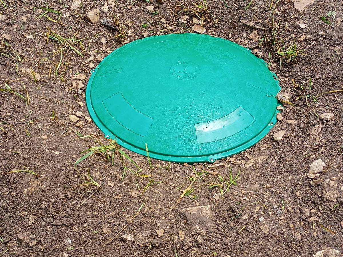New septic riser and green lid set flush at grade — Grease Goblins job photo, Bradenton FL